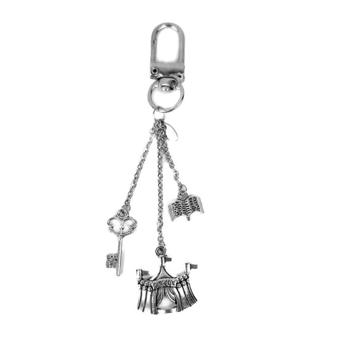 Silver keycharm with circus, key and book charms