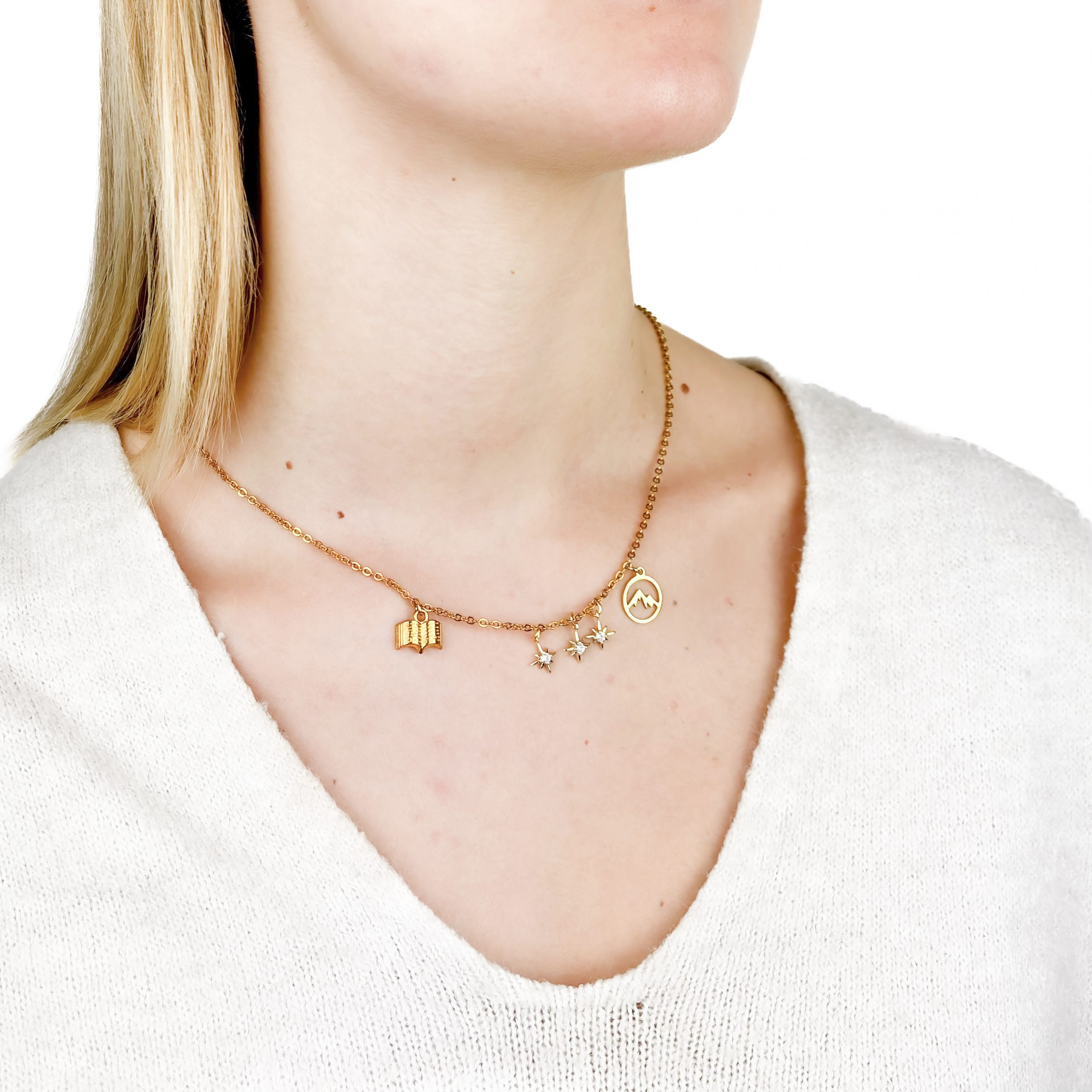 Golden necklace with mountain, stars and book charms